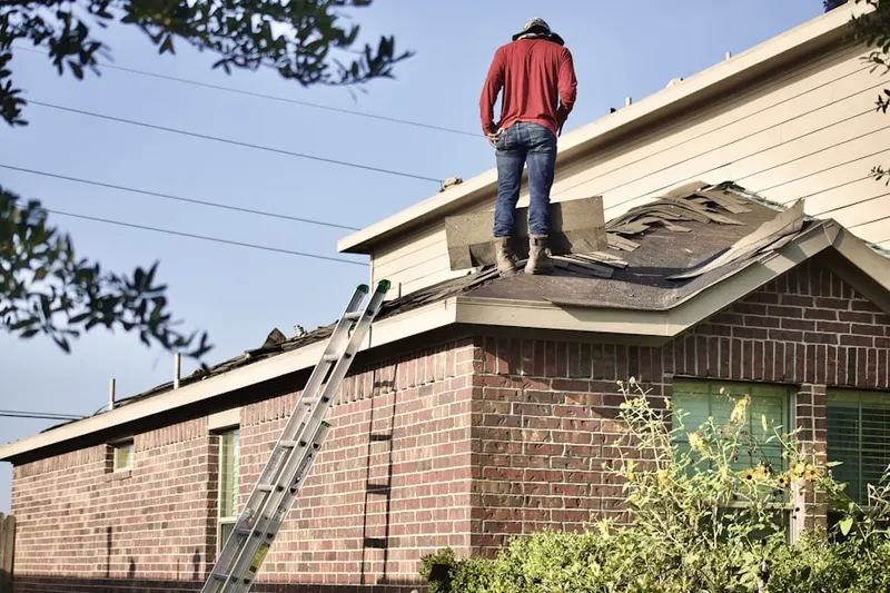 Professional roofer working on a residential roof in Laurel Heights